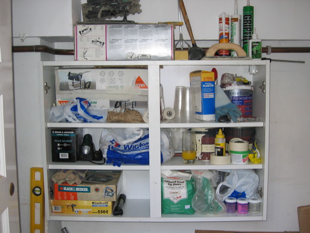 a white shelf full of items in a kitchen