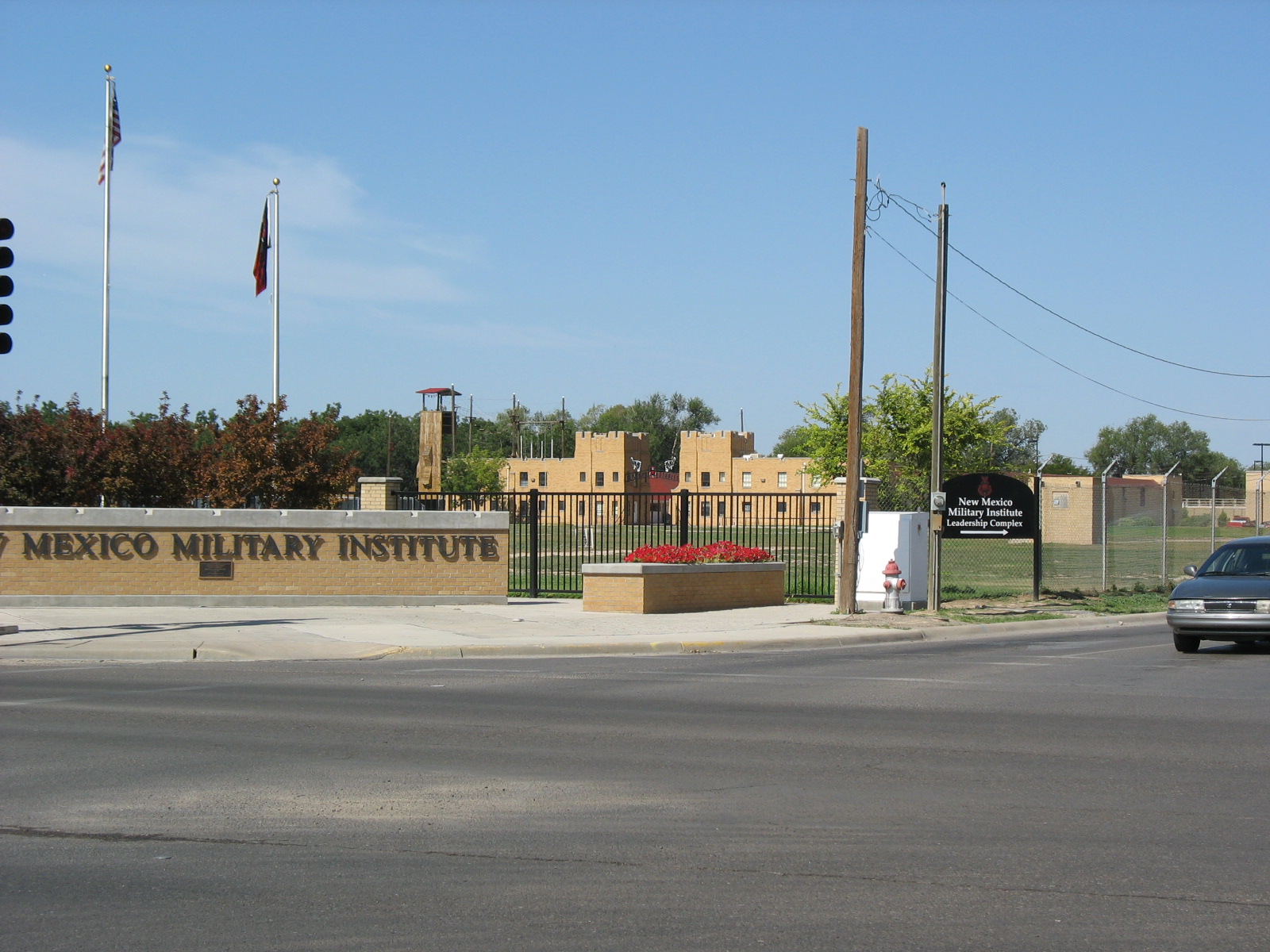 a car driving past a large sign on the side of a road