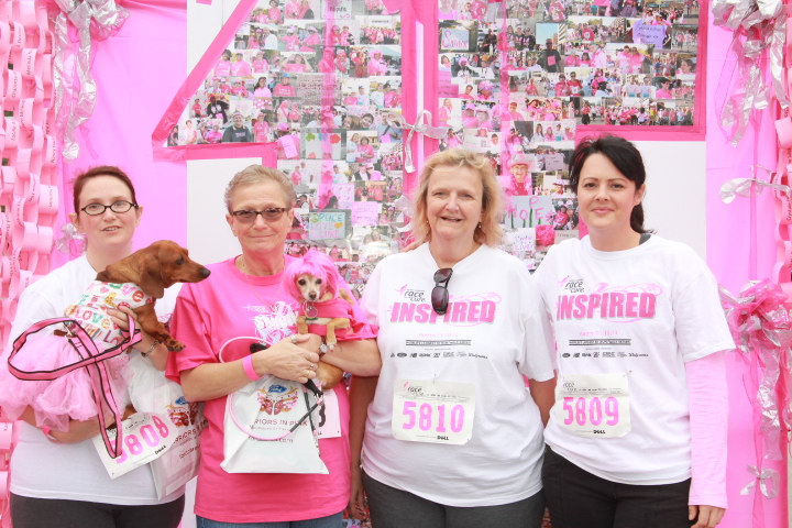 a group of women posing together with their puppies