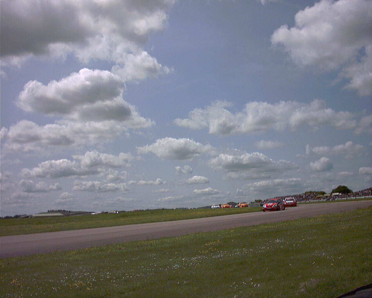 cars are driving down a road past an empty road