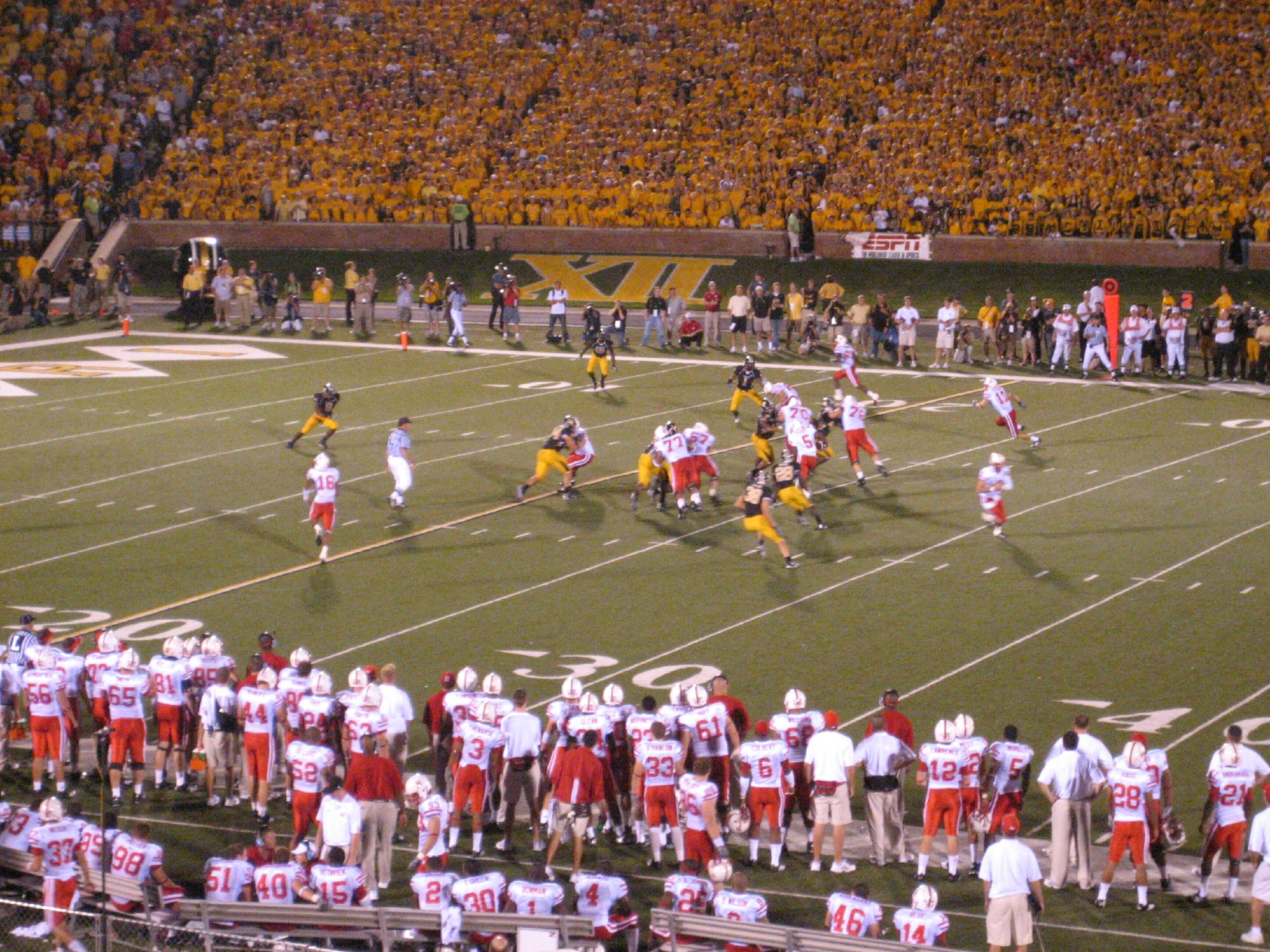 a football game being played with the red and white uniforms