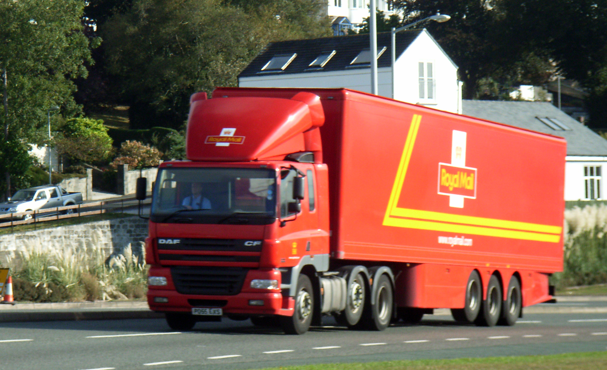 the truck is driving on a quiet road