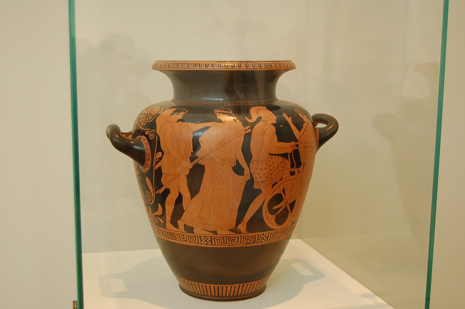 an old greek vase on display in a glass case