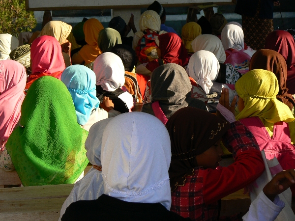 a group of people in bright colored headscarves