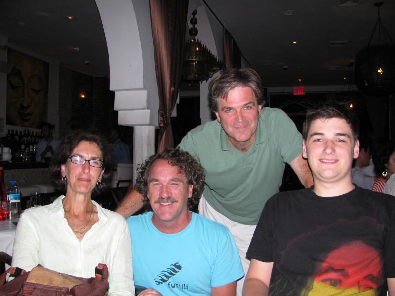 three people sitting at a table in a restaurant