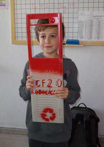 a child holding a large red and white piece of cardboard