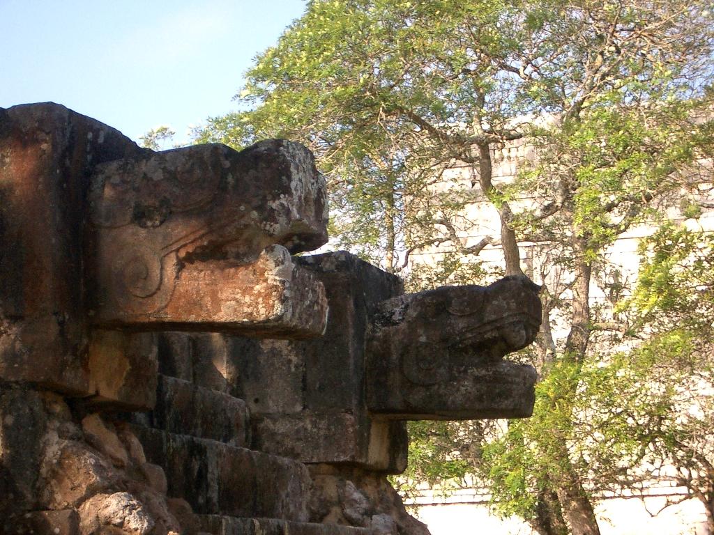 a close up of several faces on the face of some bricks