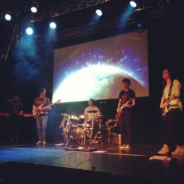 two band playing on stage at night