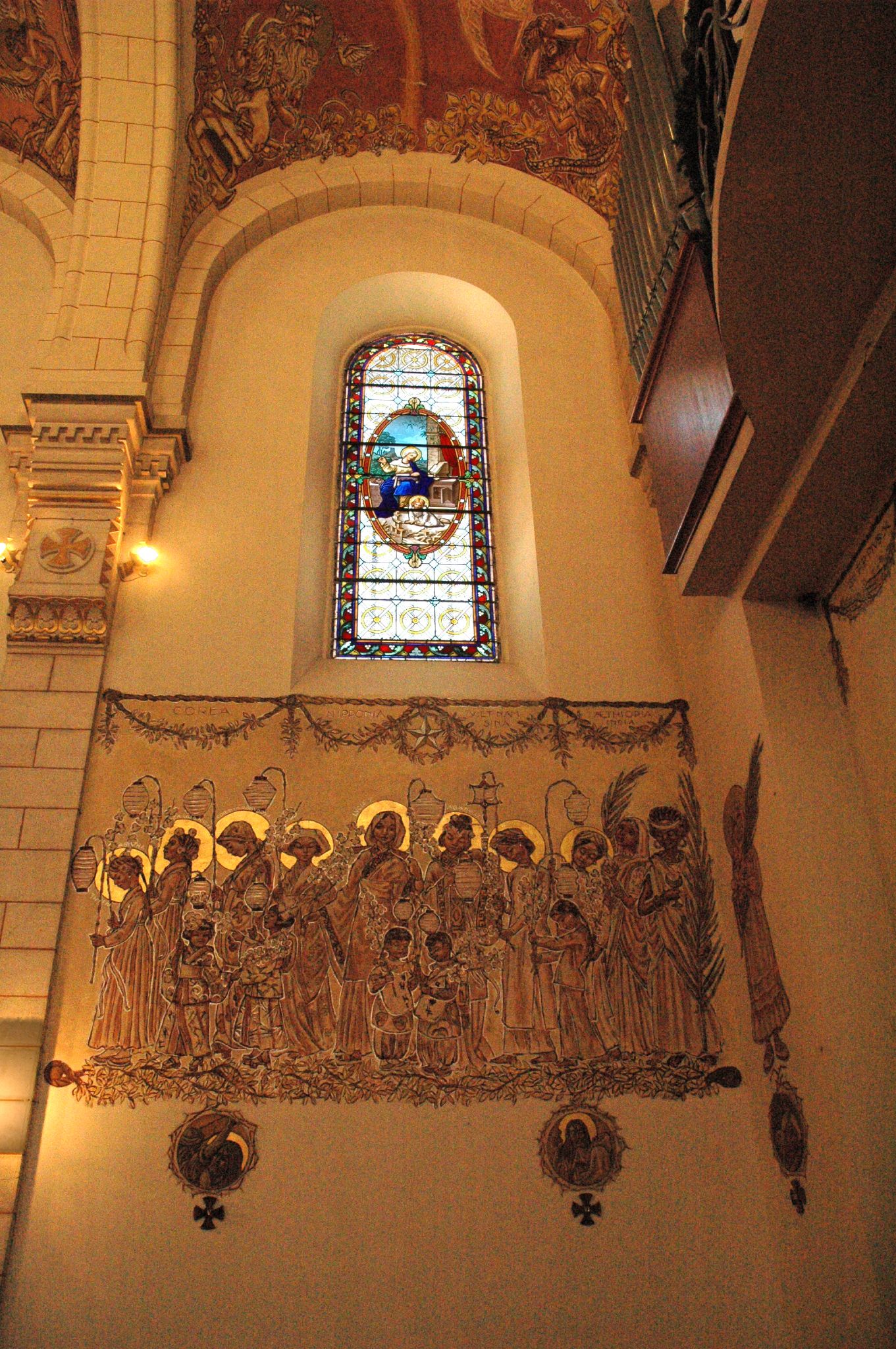 a large group of statues in front of a stained glass window