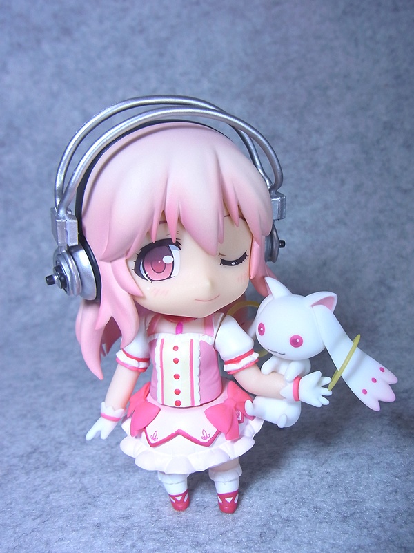 a girl wearing headphones is holding a cat and a mouse