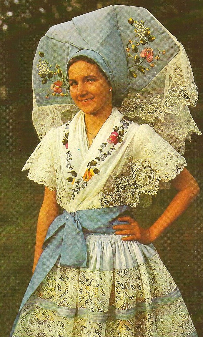 a woman wearing an elaborately designed dress and an umbrella