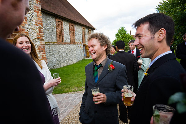 group of people in the yard laughing and having drinks