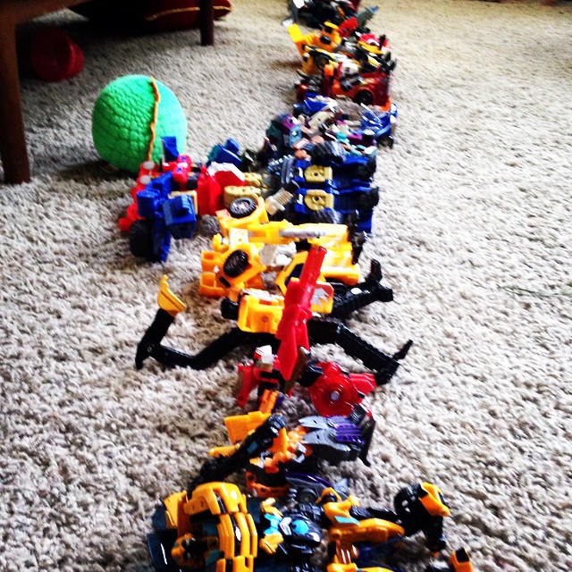 many toys laying on the floor in a row