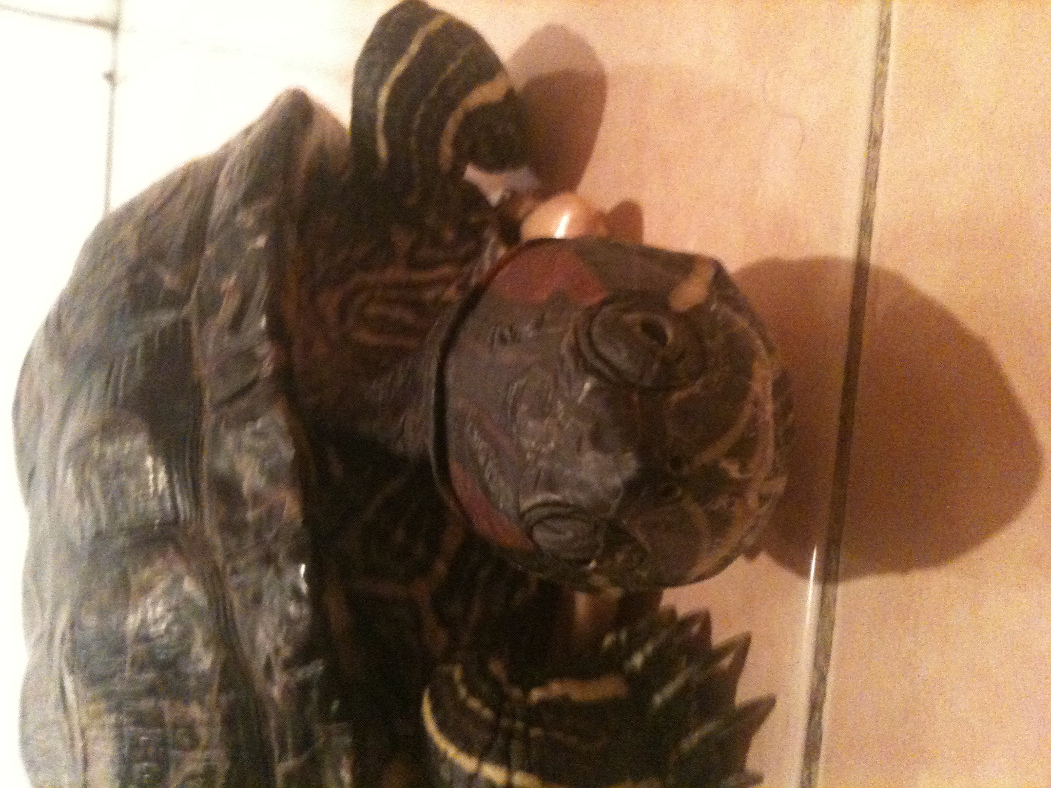 large black, brown, and orange figurine on display