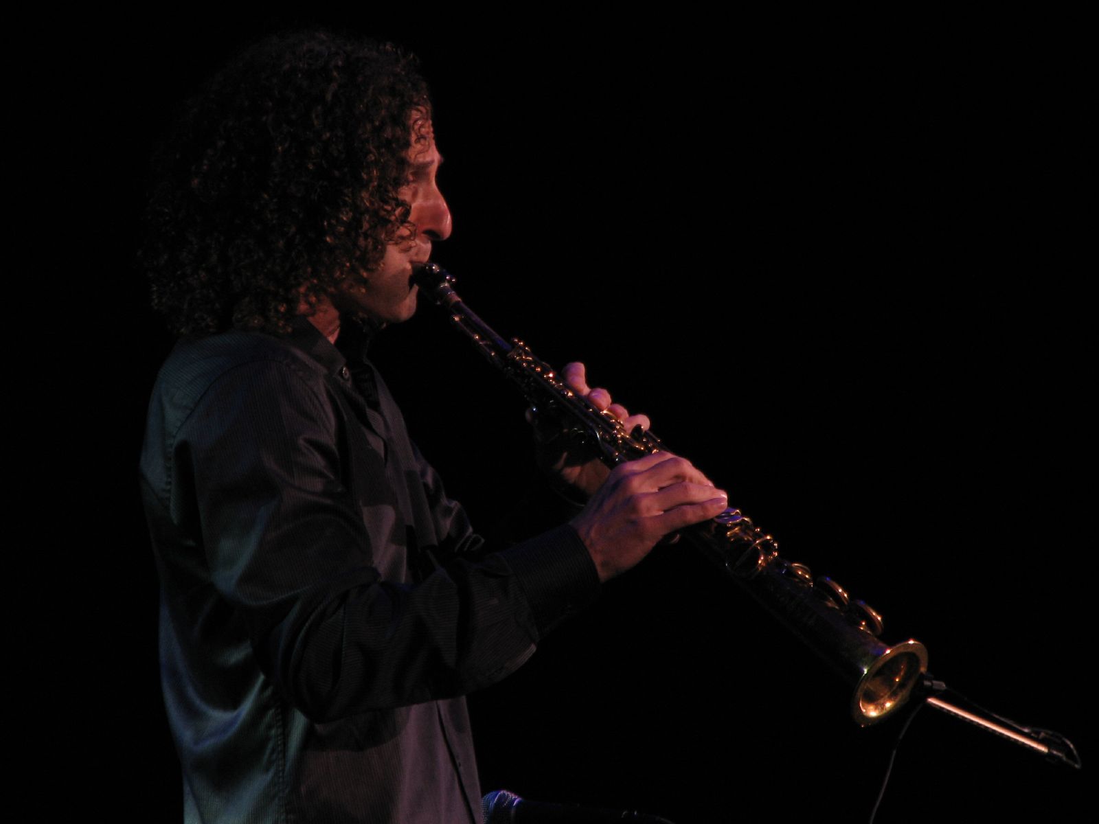 a man that is playing a saxophone on stage