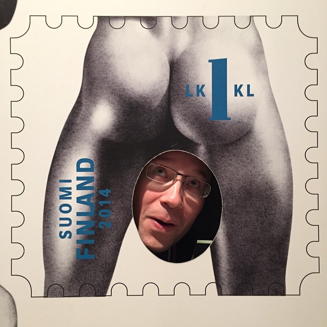 a man's face is seen behind an postage stamp