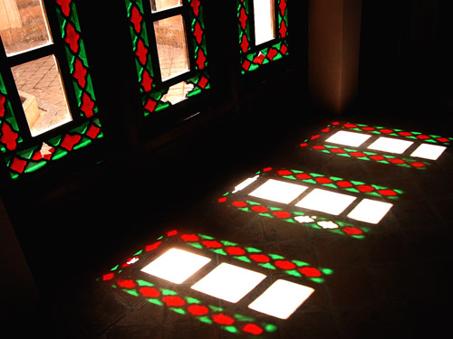 two identical square windows illuminated by green and red light