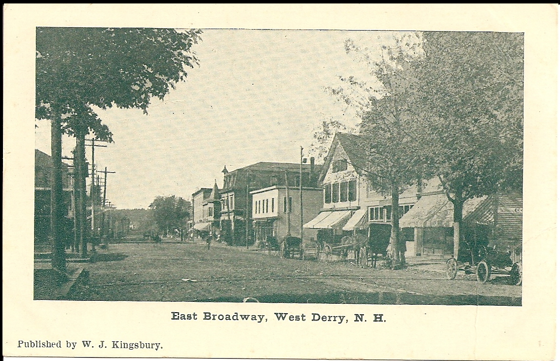 an old po shows several shops along side some buildings