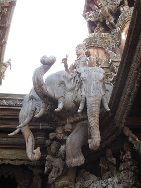 statue of a man riding an elephant in an intricate setting