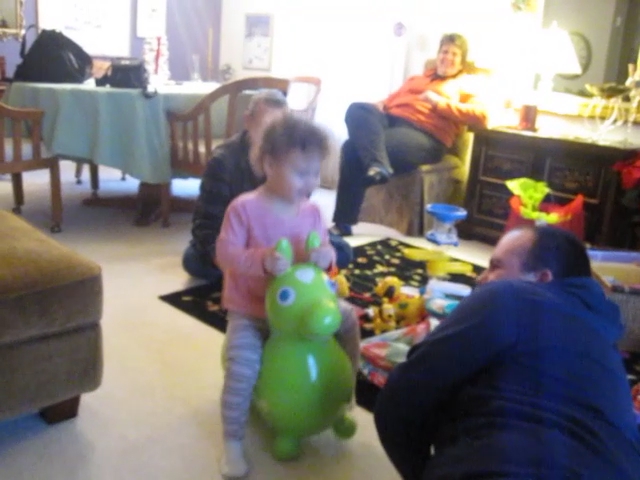 two people and a little girl are playing in the living room