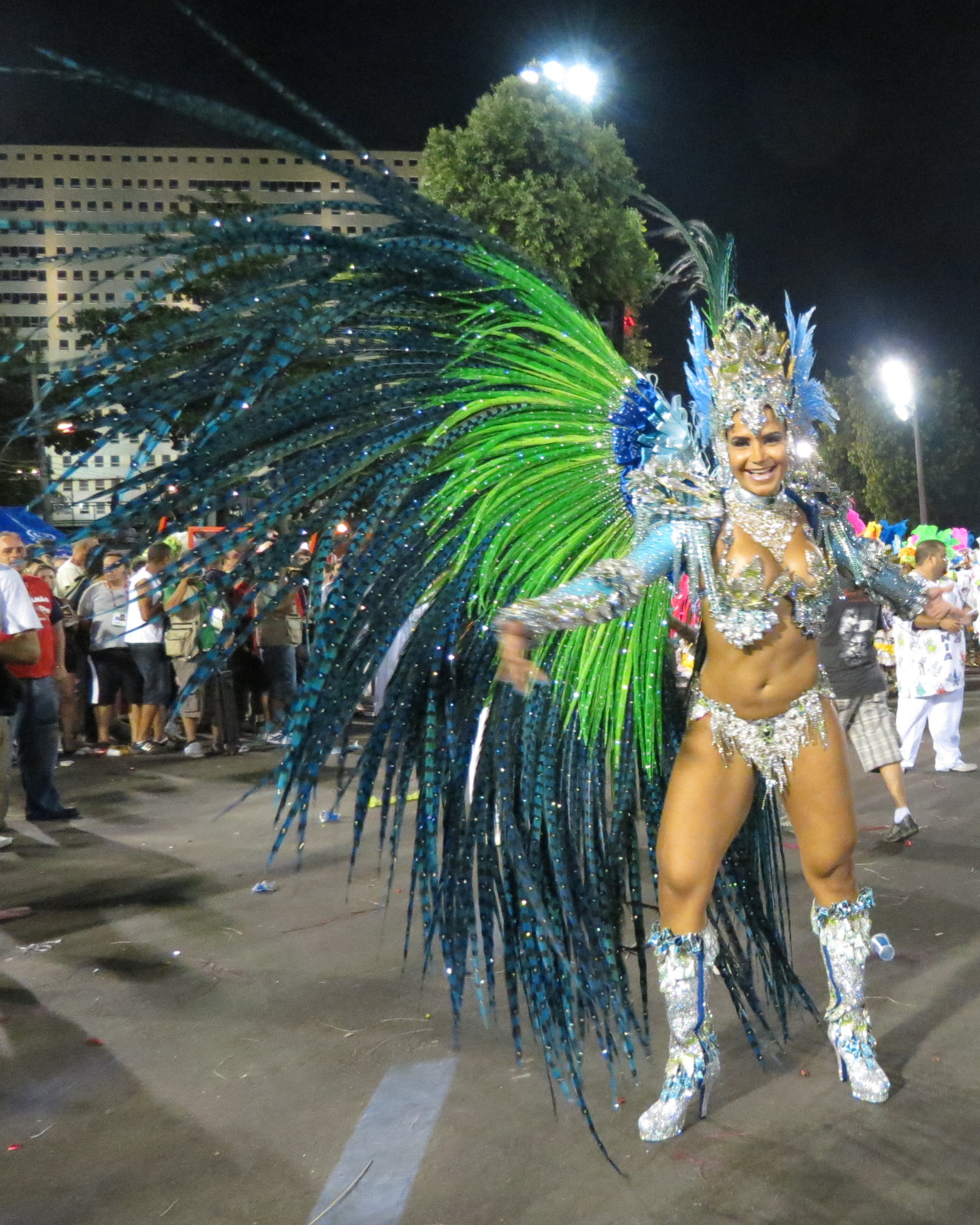 a female dancer in full costume with lots of feathers