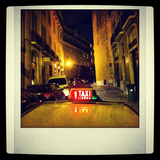 an image of taxi sign on street at night