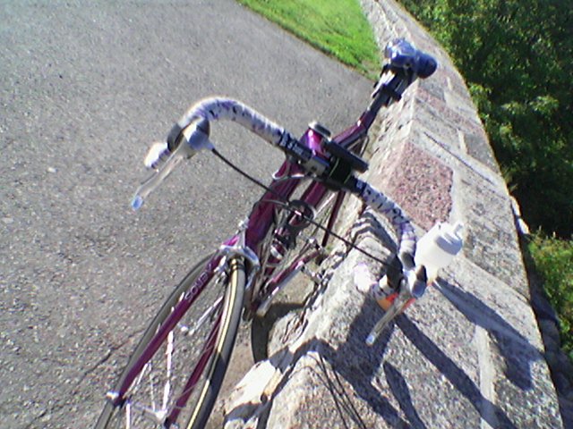 a bike locked up near a stone wall