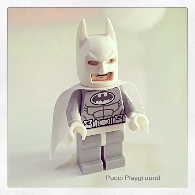 a lego batman with a batman costume on