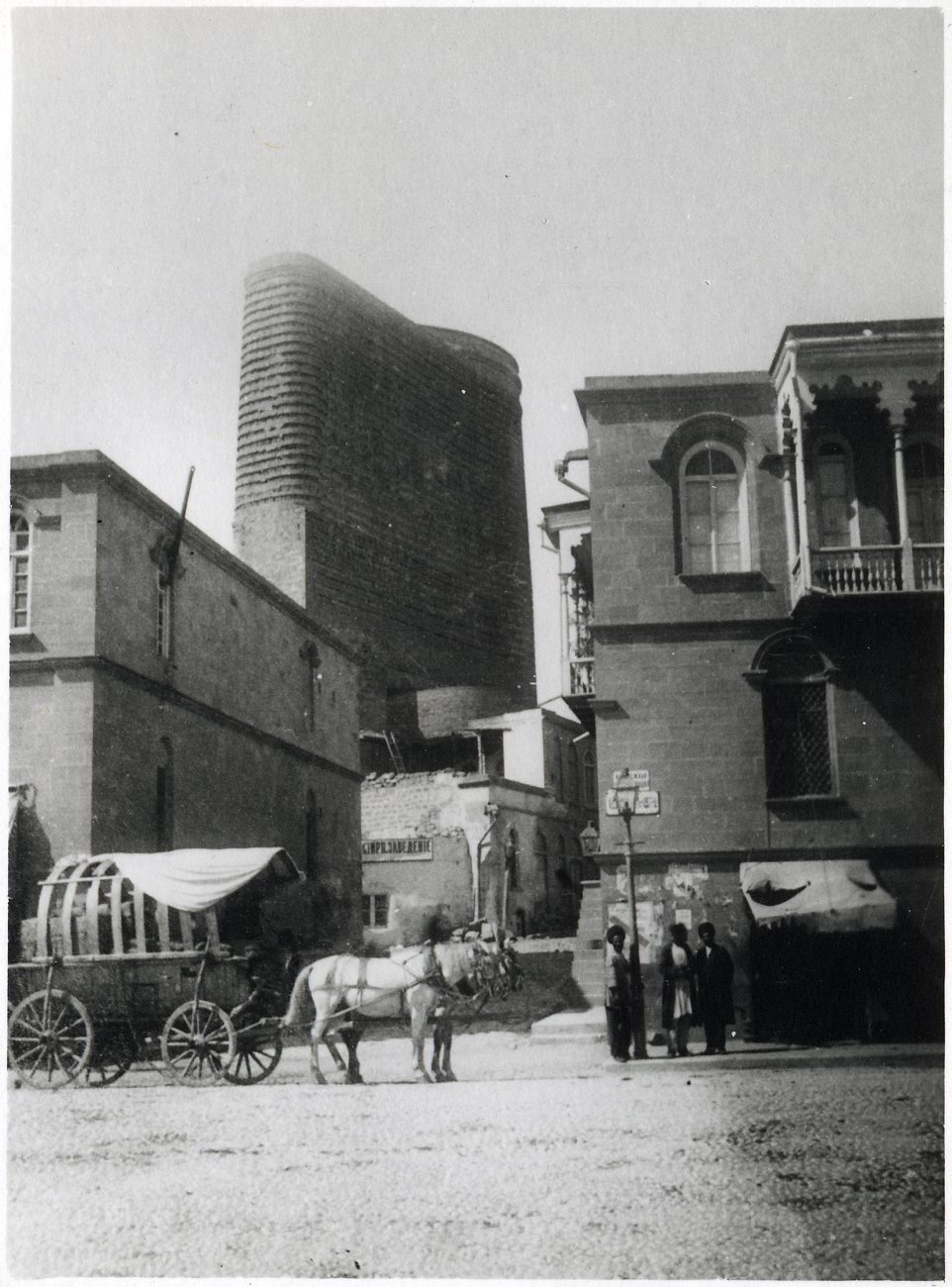 an old po of horse and buggy on an outside street