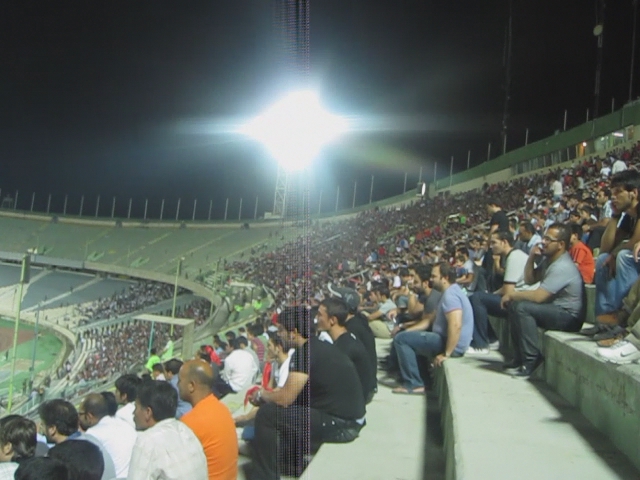 a stadium filled with people sitting on benches