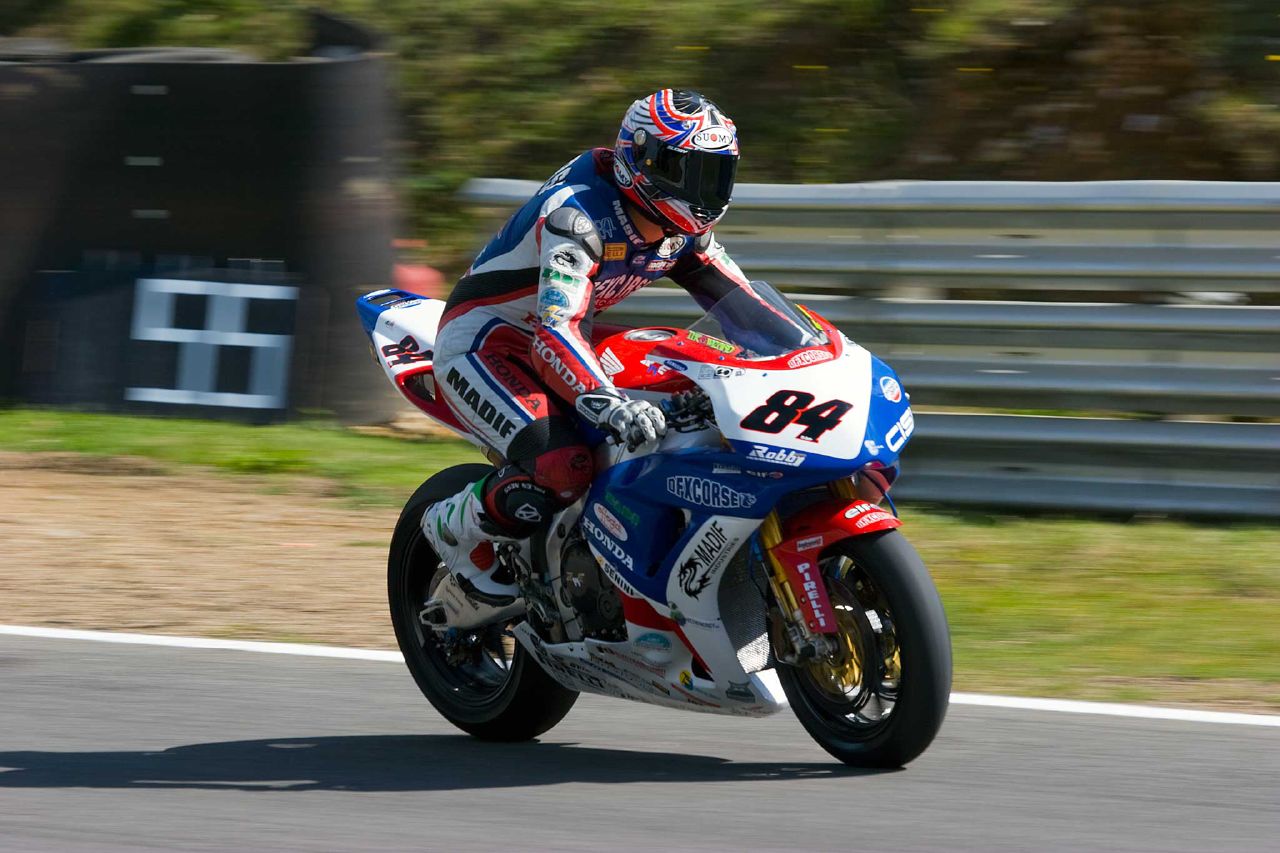 a motorcycle rider on a race track during the day