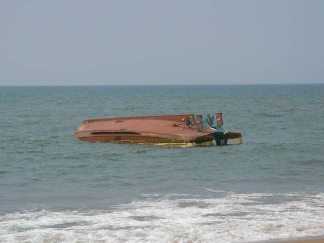 the large sunken ship is on land by the beach