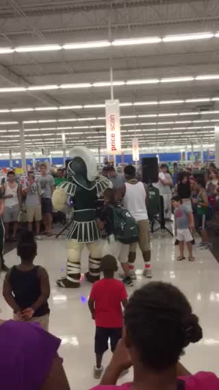two men are dancing with children in the middle of an aisle