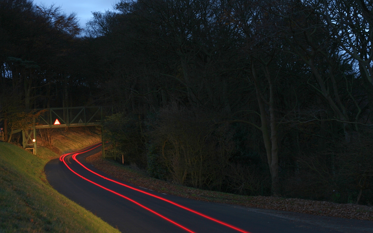 cars streaking by oncoming traffic at night