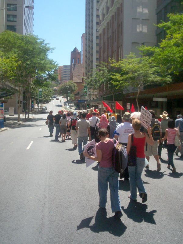 a group of people walk down the street