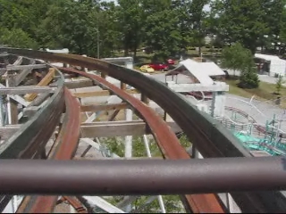 the aerial view of a roller coaster in an amut park