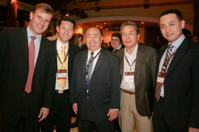 a group of men standing together in business attire