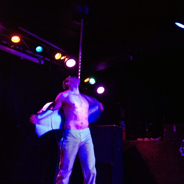 a man standing on a stage with his shirt off