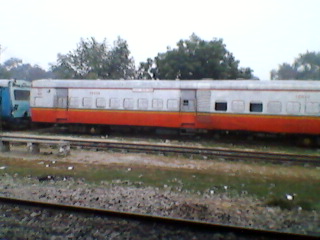 an old train sits parked near an empty track