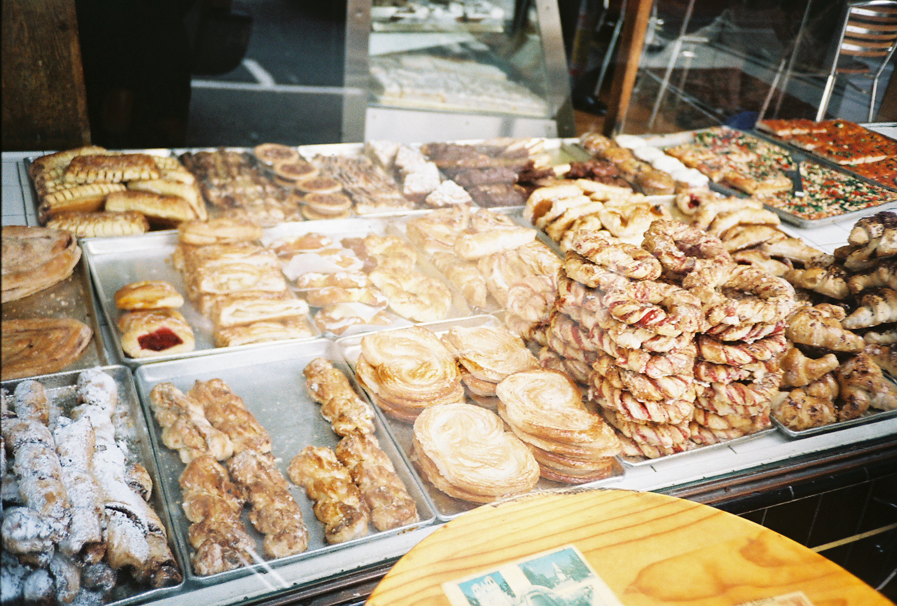 a bakery displays various pastries and donuts