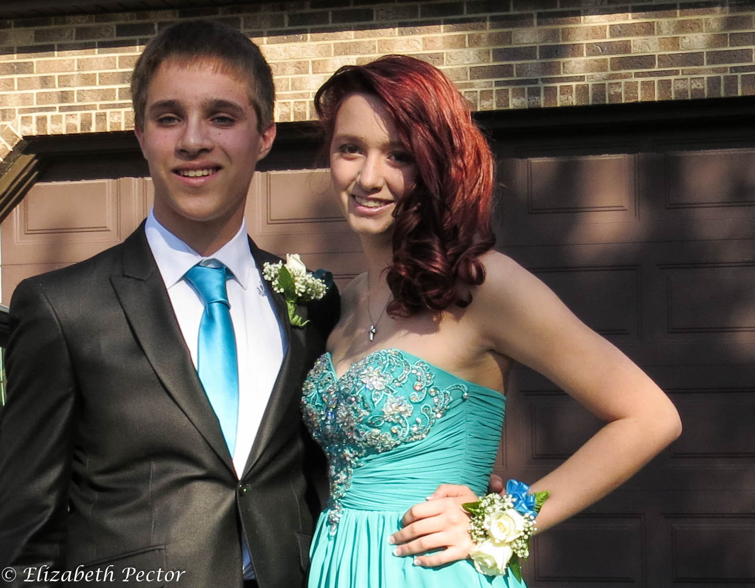 boy and girl in dress clothes posing for picture