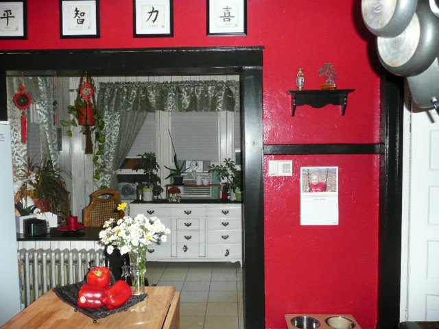 the kitchen is decorated in red and white