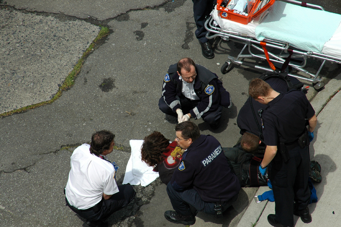 police officials confers with someone on the ground