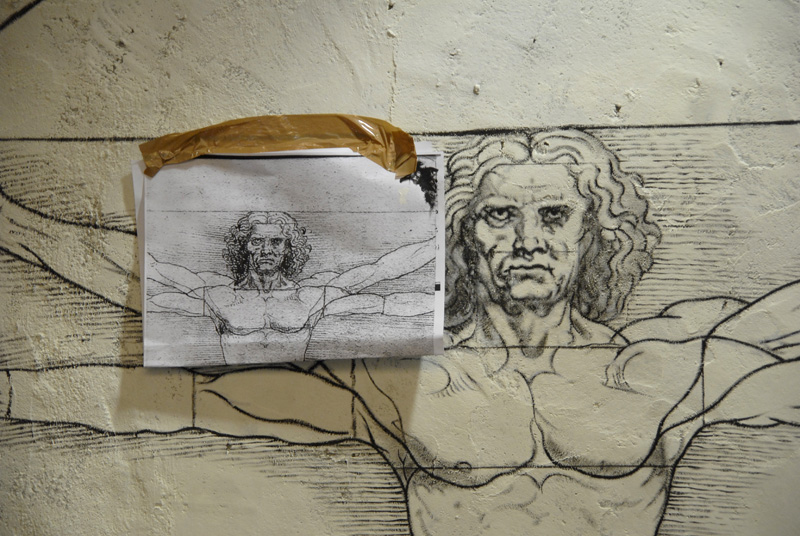 a piece of artwork with a drawing of jesus and a mans face