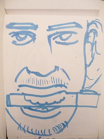 a drawing of a man's face on a piece of paper