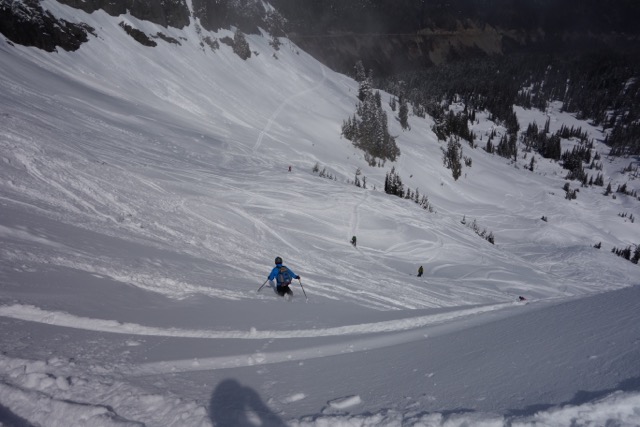 skier coming down the slopes towards the top of a hill