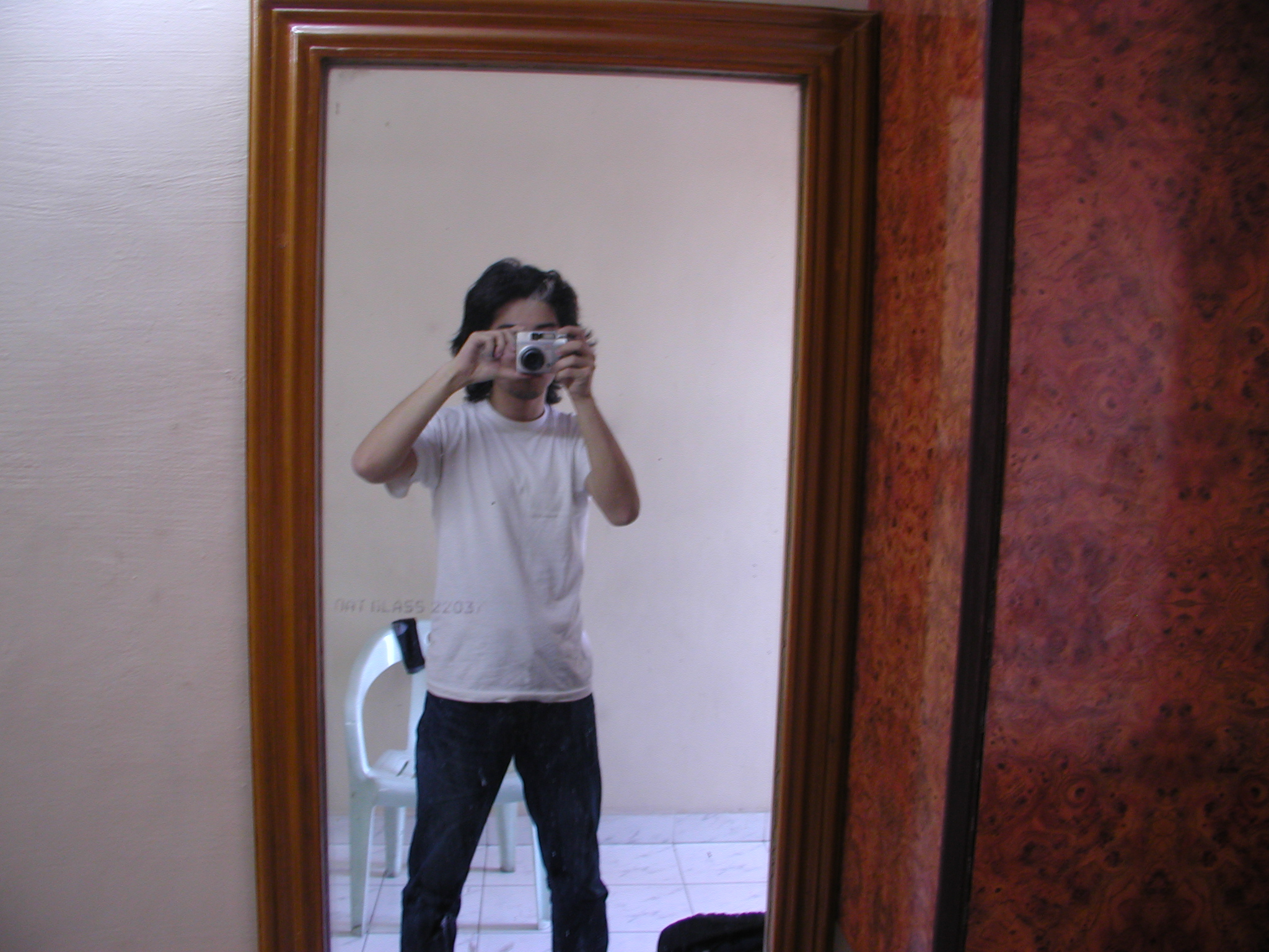 a man taking his own picture in the bathroom mirror