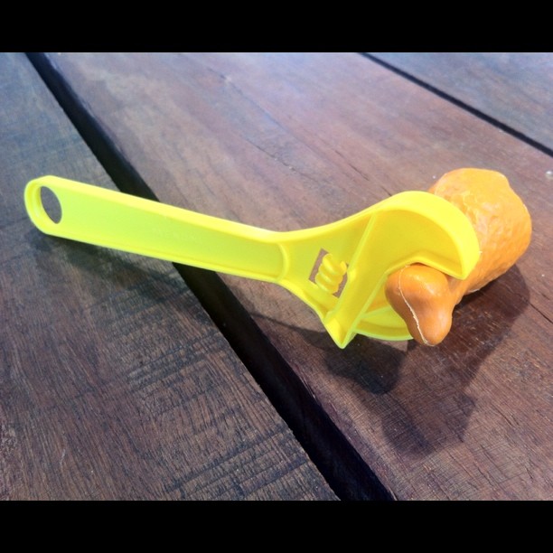 a plastic yellow toy with scissors on it