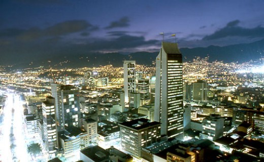 view of city at night, with lights shining on buildings