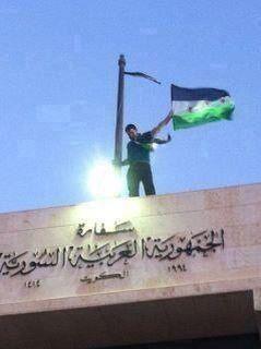 a person waving a flag on top of a building